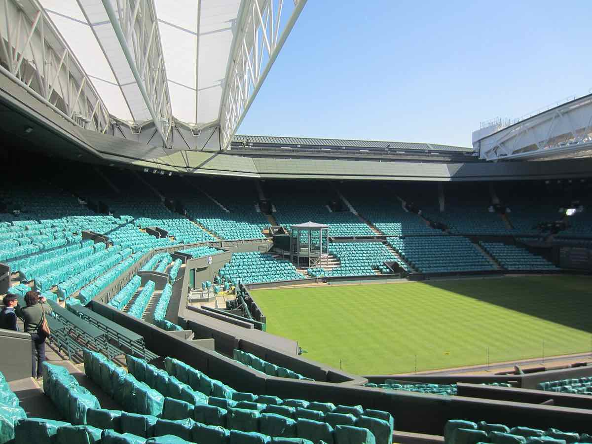 Il Centre Court di Wimbledon, con il campo in erba e le tribune verdi, vuoto fuori dalla stagione del torneo